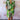 Colorful wave pattern knee-length summer dress in multicolor with a V-neck design, featuring short sleeves and a fitted waist, worn by a fashion model.