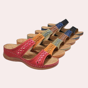 Colorful women's bohemian beaded slip-on sandals featuring vibrant magenta accents, designed as summer flats with a comfortable wedge sole.