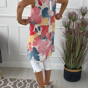 Colorful women's sleeveless blouse with a vibrant floral watercolor design, perfect for summer wear.