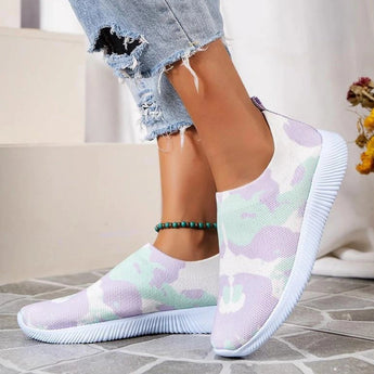 A pair of colorful women's slip-on walking sneakers in a rainbow mesh design, shown in a purple color variant, size 42, displayed on a neutral background.