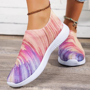 Colorful women's slip-on walking sneakers with a rainbow mesh design, featuring a lightweight build, predominantly in shades of purple, pink, and violet.
