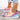 Colorful women's slip-on walking sneakers with a rainbow mesh design, shown on a model wearing jeans. The lightweight sneakers, size 42, feature vibrant hues and are designed for comfort and style.