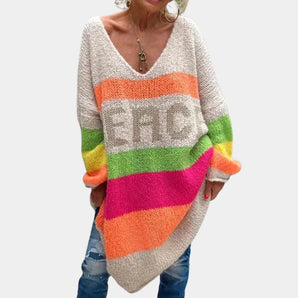 Colorful women's oversized long sleeve sweater featuring a V-neck design with striped patterns, showcasing a woolen texture in shades of grey.