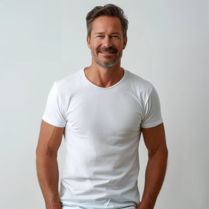 A man wearing a comfortable men's premium cotton white t-shirt in size XL, smiling with arms and shoulders visible.