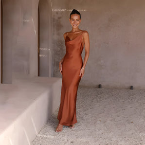 Copper satin one-shoulder evening gown showcasing elegant formal wear with a fitted waist, asymmetrical neckline, and flowing skirt, perfect for formal occasions.