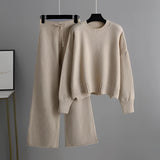 Cozy cream knit sweater with long sleeves and matching wide-leg pants set on a clothes hanger, showcased in a beige color, ideal for winter loungewear.