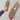 Light grey cozy fleece slippers for women, featuring a soft plush design and an anti-slip sole. The image shows a close-up view of the slippers, highlighting their snug interior and fashionably simple pattern. A hand is visible, possibly adjusting the slipper.