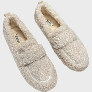 Light grey women's cozy fleece slippers with a soft plush exterior and anti-slip sole, featuring a slide sandal design.