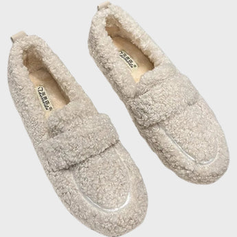 Light grey women's cozy fleece slippers with a soft plush exterior and anti-slip sole, featuring a slide sandal design.