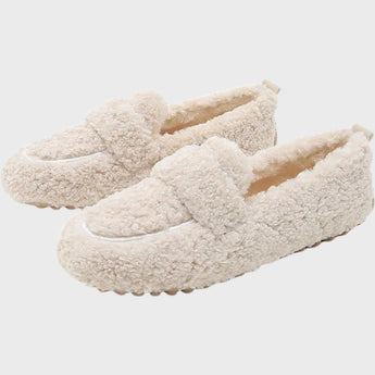 Light grey women's slippers made of soft plush material featuring an anti-slip sole, designed for comfort and warmth.