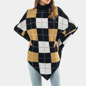 
A cozy oversized plaid turtleneck poncho sweater showcasing a stylish fall fashion design. The garment features a classic tartan pattern with a high collar and loose sleeves, providing a comfortable and chic outerwear option for cooler weather.