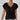 A woman wearing an elegant black short sleeve blouse paired with jeans, highlighting the blouse's stylish collar and comfortable fit.