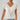 Elegant cream blouse with short sleeves and a stylish collar, designed for work and casual occasions. The women's top is shown in a white color and size XL, paired with jeans in the image.