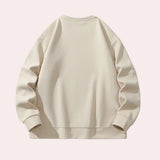 Unisex cream crewneck sweatshirt featuring a minimalist design, showcasing long sleeves and a comfortable casual fit.