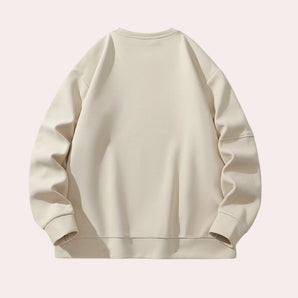 Unisex cream crewneck sweatshirt featuring a minimalist design, showcasing long sleeves and a comfortable casual fit.