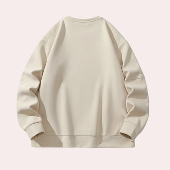 Unisex cream crewneck sweatshirt featuring a minimalist design, showcasing long sleeves and a comfortable casual fit.