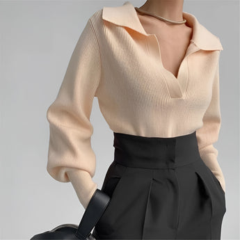 Cream high-neck cropped sweater featuring stylish back detail, displayed on a model. The sweater has long sleeves and is shown in a beige color, size large.
