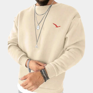 Cream men's crewneck sweatshirt in a minimalistic urban style with a small bird logo, shown in beige color and 3XL size. The garment features long sleeves and a crew neckline, providing a casual yet stylish look.