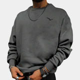 Cream men's crewneck sweatshirt in minimalistic urban style with a small bird logo on the chest, shown in gray color, size 3XL. The garment features long sleeves and a relaxed fit, suitable for casual wear.