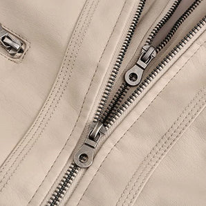 Cream women's fitted leather jacket with zipper details, featuring long sleeves and a sleek design, displayed on a neutral background.