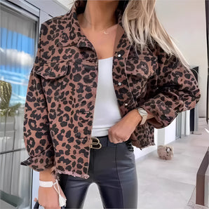 Cropped women's leopard print denim jacket with stylish design, featuring a blend of black and white colors, long sleeves, and a trendy fashion-forward look.