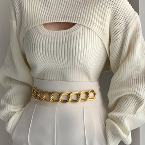 White cutout ribbed knit sweater with puffed sleeves, featuring a trendy winter fashion design, shown as a one-piece garment on a mannequin.