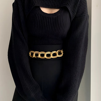 
A fashionable cutout ribbed knit sweater featuring puffed sleeves, showcasing trendy winter fashion with a focus on the sleeve and waist details.