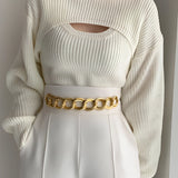 Puffed sleeve ribbed knit sweater with a cutout design, featuring a round neckline and fitted waist, suitable for trendy winter fashion.