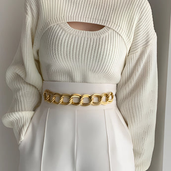 Puffed sleeve ribbed knit sweater with a cutout design, featuring a round neckline and fitted waist, suitable for trendy winter fashion.