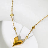 Dainty 18K gold heart pendant necklace featuring a delicate chain, designed as an elegant and romantic jewelry gift.