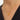 A hand holding an elegant 18K gold heart pendant necklace around the neck, showcasing its dainty, romantic design.