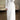 
A white pleated A-line dress with bishop sleeves, featuring a formal evening wear style, designed in a one-piece garment form.