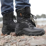 Delta Tactical Boots in sand color, designed for military combat and all-terrain hiking, shown being worn by a person standing outdoors on grass, wearing jeans.