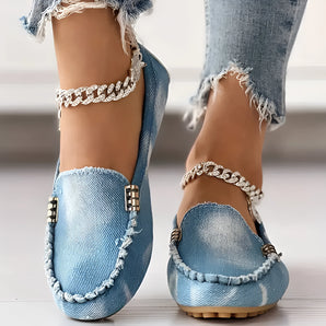 Denim ballet flats for women featuring rhinestones and an ankle chain, shown on a model's foot against a white background.