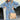 Blue oversized denim mini dress with puffed sleeves and a belted waist, shown on a mannequin.