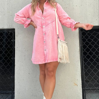 
A plus-size pink denim mini dress with an oversized, belted design and puffed sleeves, featuring a shirtdress style and knee-length cut.