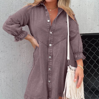 Denim mini dress with a belted waist, oversized fit, and puffed sleeves in a shirtdress style, shown in a Viola color and 3XL size. The image may include accessories such as sunglasses.