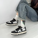 Denim and suede star design sneakers in Nero color, size 40, showcasing a trendy urban style with a grey tartan pattern, suitable for casual and sportswear, displayed on a human leg.