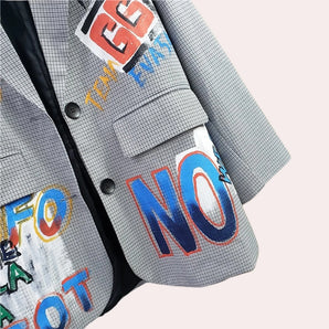 
A stylish graffiti blazer featuring custom urban text with a vibrant electric blue color and bold graphic patterns.