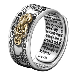 A mixed metal dragon ring in silver and gold with etched Chinese characters, designed as a piece of body jewelry.