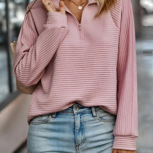 Dusty rose ribbed quarter-zip pullover for women, showcasing a stylish autumn fashion look, paired with jeans.
