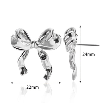 Gold-colored earrings featuring intricate bound shapes design, styled as a fashionable accessory.