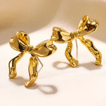 Gold earrings designed with bound shapes, featuring electric blue accents and intricate metalwork, suitable as fashionable body jewelry.