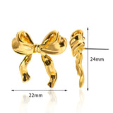 Artistic earrings featuring intricate knot designs, resembling bound shapes, styled as a fashion accessory.