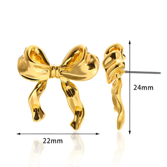 Artistic earrings featuring intricate knot designs, resembling bound shapes, styled as a fashion accessory.
