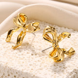 Gold earrings featuring intricate knot designs and feather details, suitable for special events or wedding ceremonies.