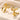 Gold earrings featuring intricate knot designs and feather details, suitable for special events or wedding ceremonies.