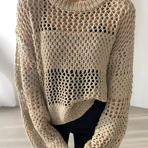 Eco-friendly beige crochet sweater displayed on a mannequin, featuring a handmade loose-fit design with long sleeves and a textured textile pattern.