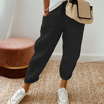 Eco-friendly compact woven crossbody bag in a neutral color, displayed in a travel setting.