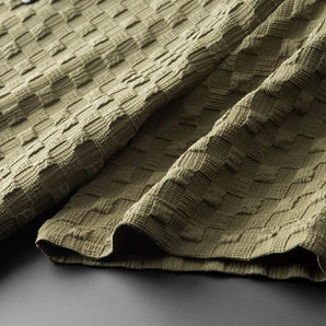 Luxurious artisan weave fabric in a rich green color with a textured pattern, suitable for eco-friendly and elegant decor projects.